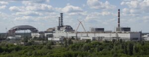 A panoramic view across the Chornobyl Nuclear Power Plant site, with the new confinement structure under construction on the left and Unit 4 near the center